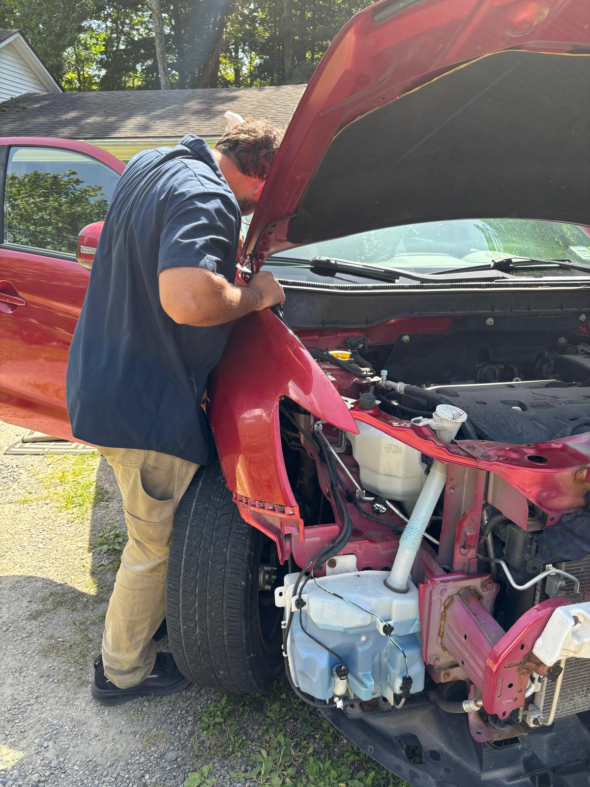 Raphael working on the Mitsubishi Outlander front fender installation